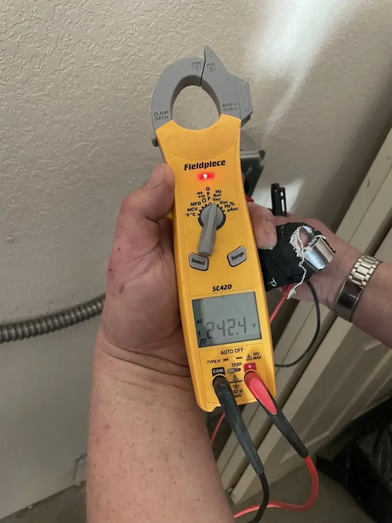 Voltage testing with clamp meter during Outlet Installation in Carmi